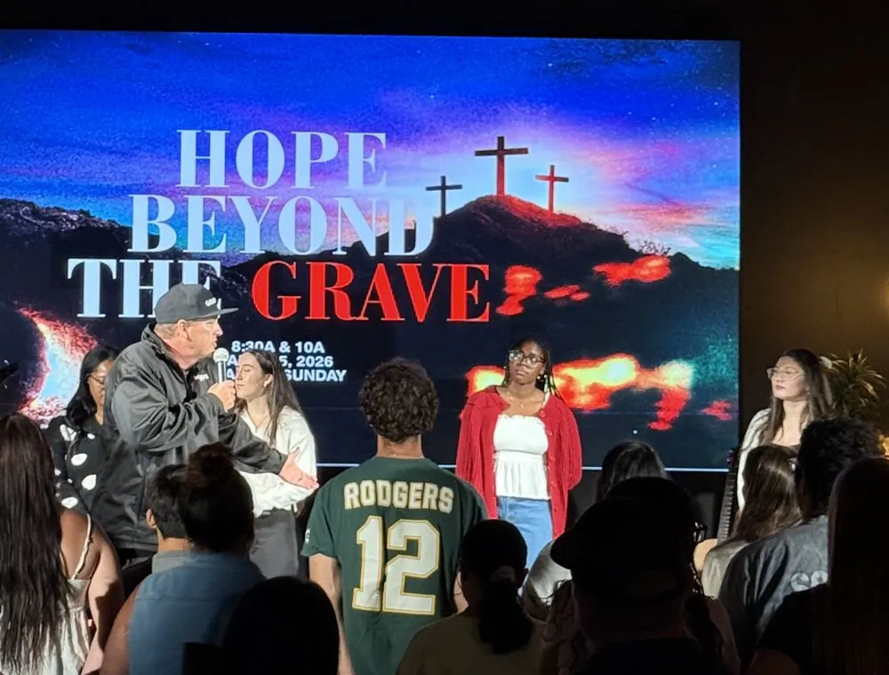 Worship team and speaker on stage