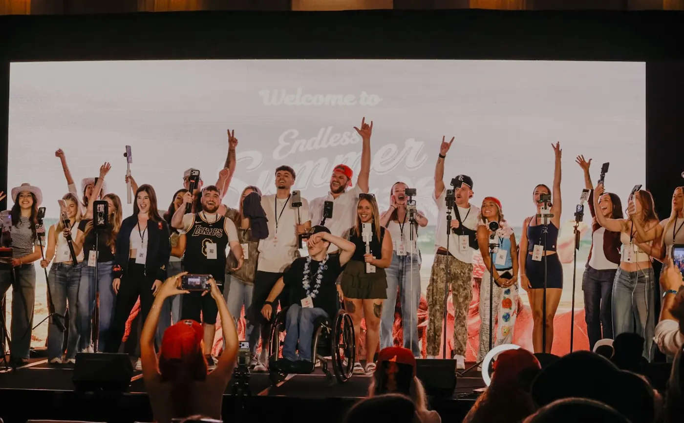 Creators on stage with phones raised at Endless Summer Games