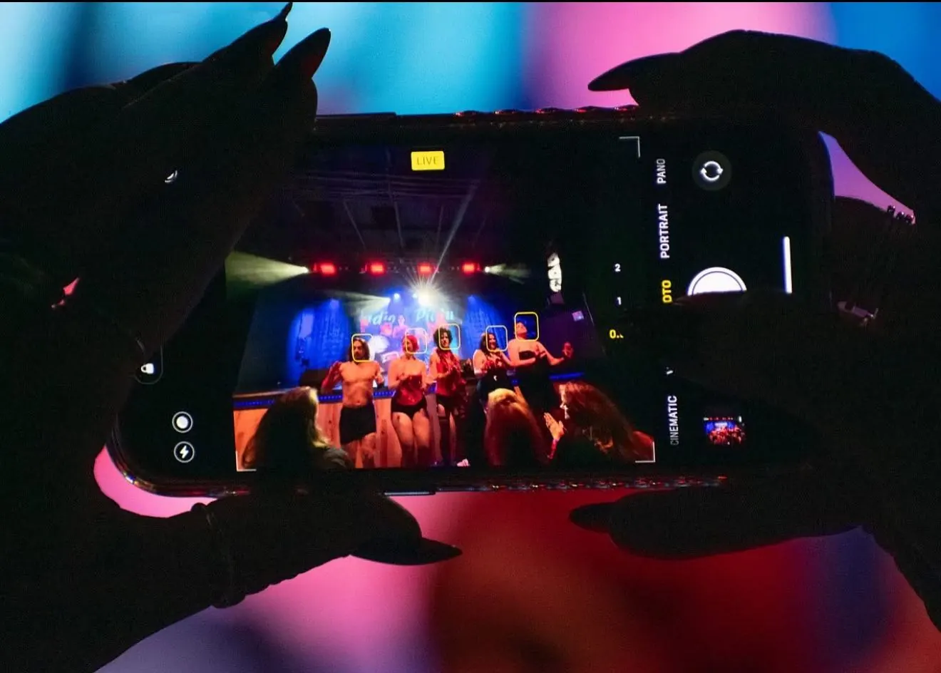 Audience member filming a live show on a phone