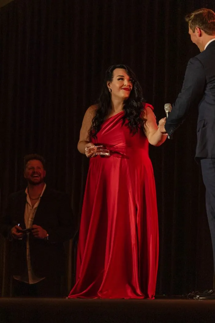 Jaimie Agan receiving an award on stage